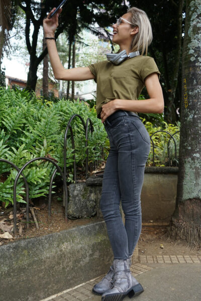 Veronica Leal posing all over her hood in green shirt and tight jeans Image #9