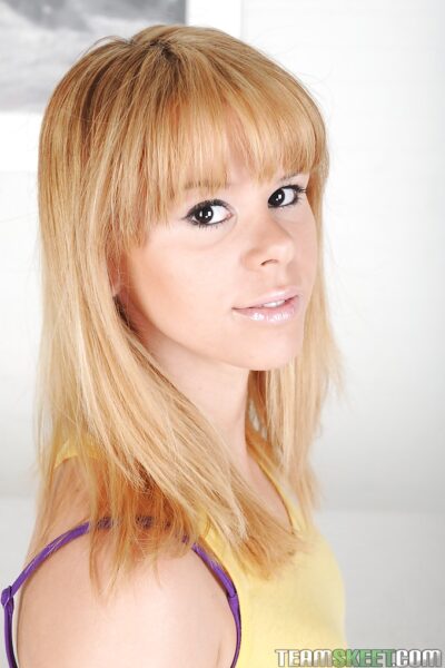 Frisky teenage blonde Elizabeth Bentley uncovering her svelte body Image #1