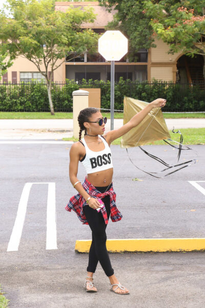 Beautiful skinny ebony babe Kendall Woods plays and flies a kite outside Image #1
