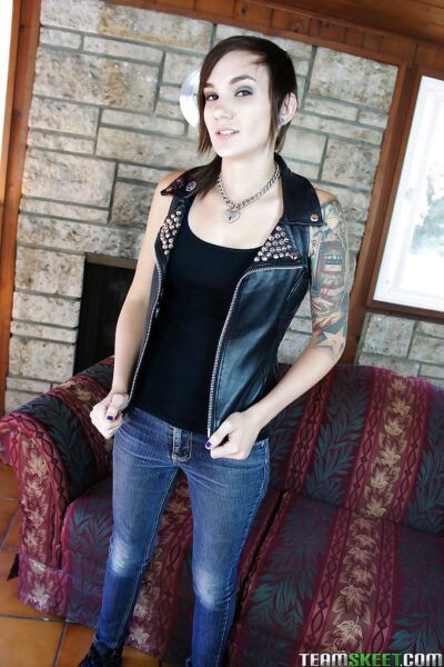 Slender tattooed babe in jeans gets naked and masturbates nicely Image #1
