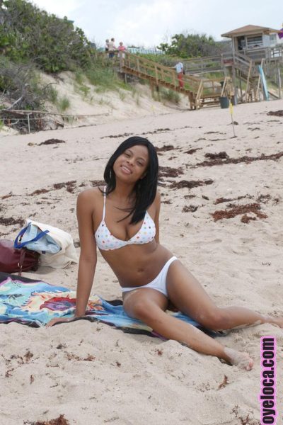 Beautiful young ebony Nina Belle with big tits sunning on the beach in bikini Image #11