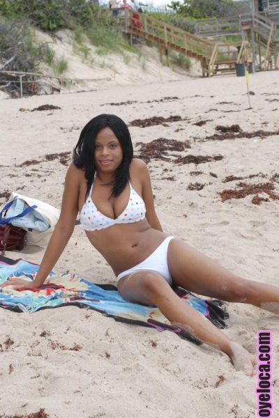 Beautiful young ebony Nina Belle with big tits sunning on the beach in bikini Image #12