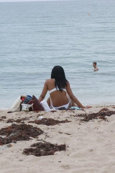 Beautiful young ebony Nina Belle with big tits sunning on the beach in bikini Image #17