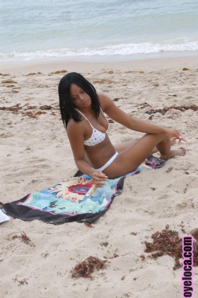 Beautiful young ebony Nina Belle with big tits sunning on the beach in bikini Image #1