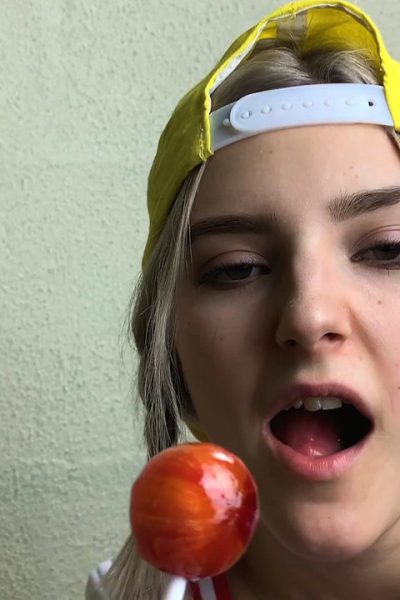 Slim teen Eva Elfie licks a lollipop and a dick while exposing her big tits Image #4