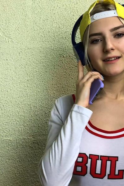 Slim teen Eva Elfie licks a lollipop and a dick while exposing her big tits Image #1